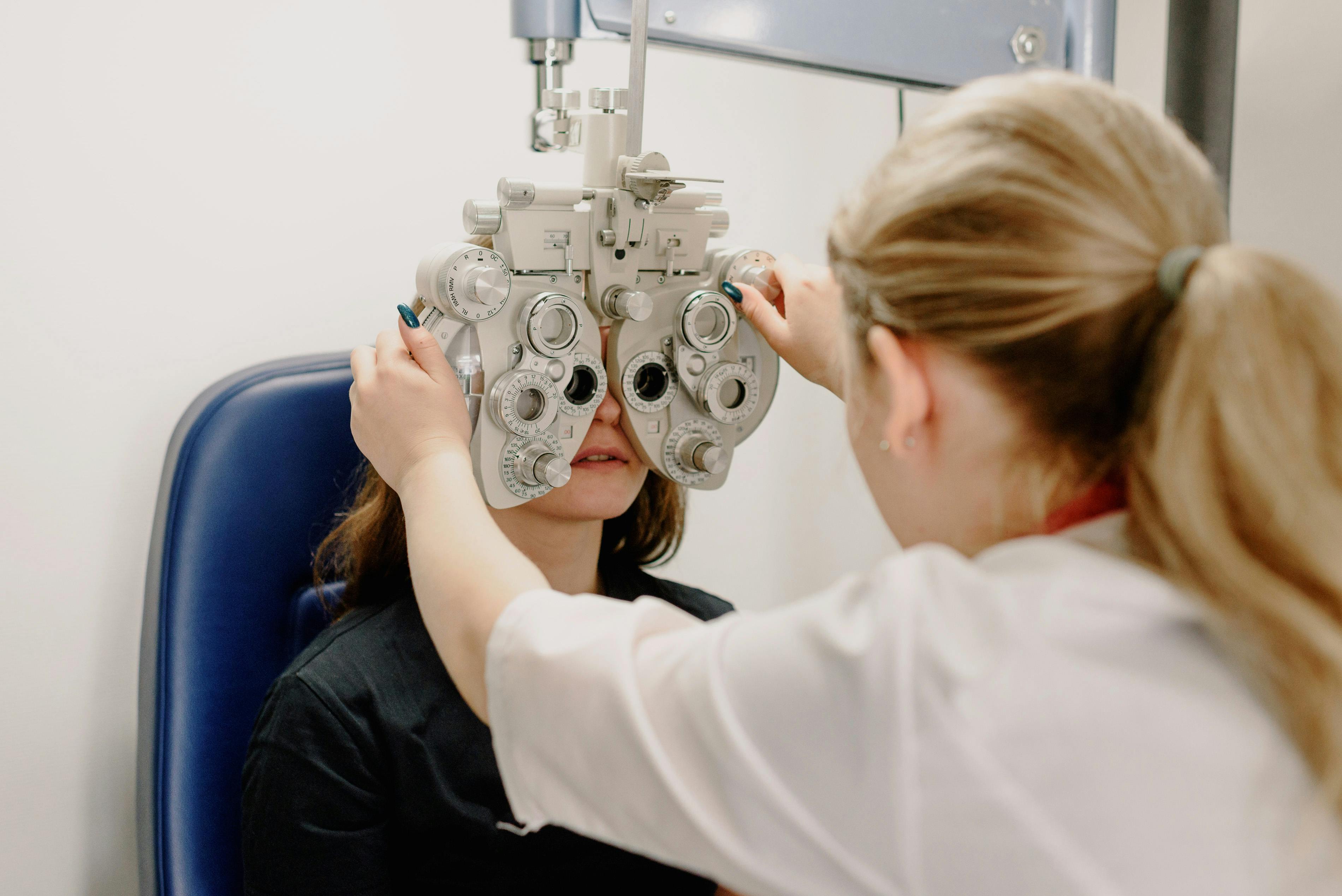 Optometrist helping a patient