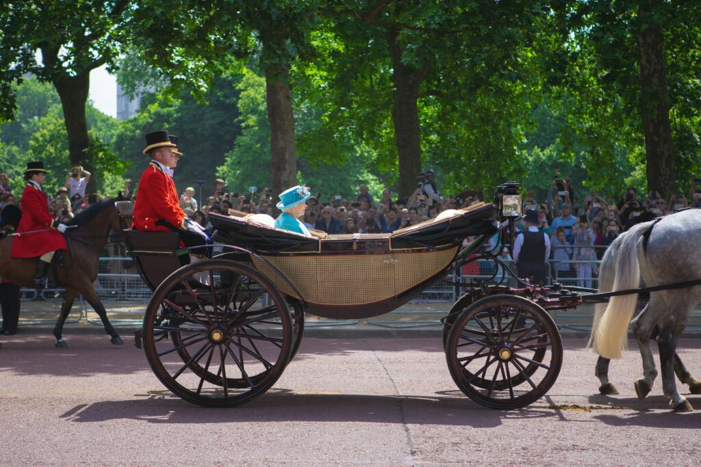 Queen Elizabeth the second riding in her carriage.