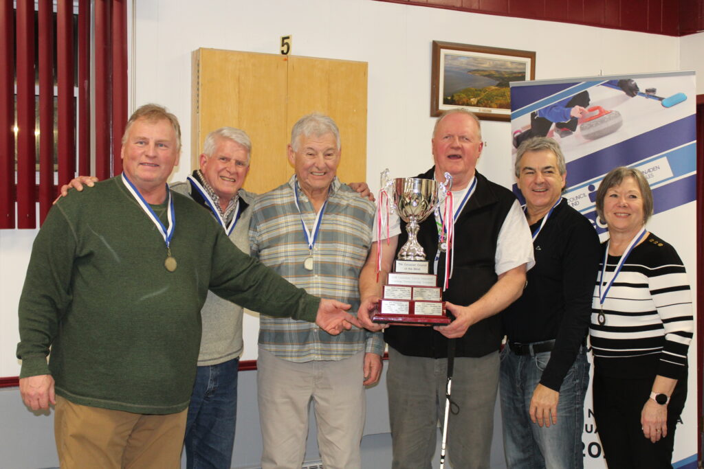 Team British Columbia (the new Team Canada) posing for the camera holding the CVICC Champions Trophy.