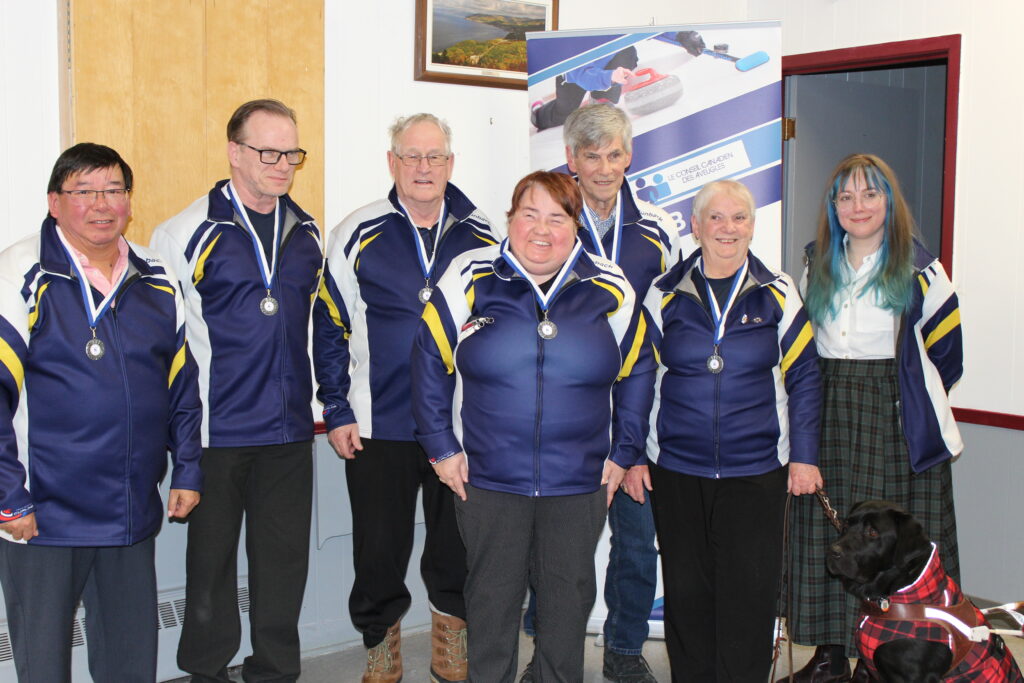 Team Nova Scotia posing for the camera with each player wearing silver medals.